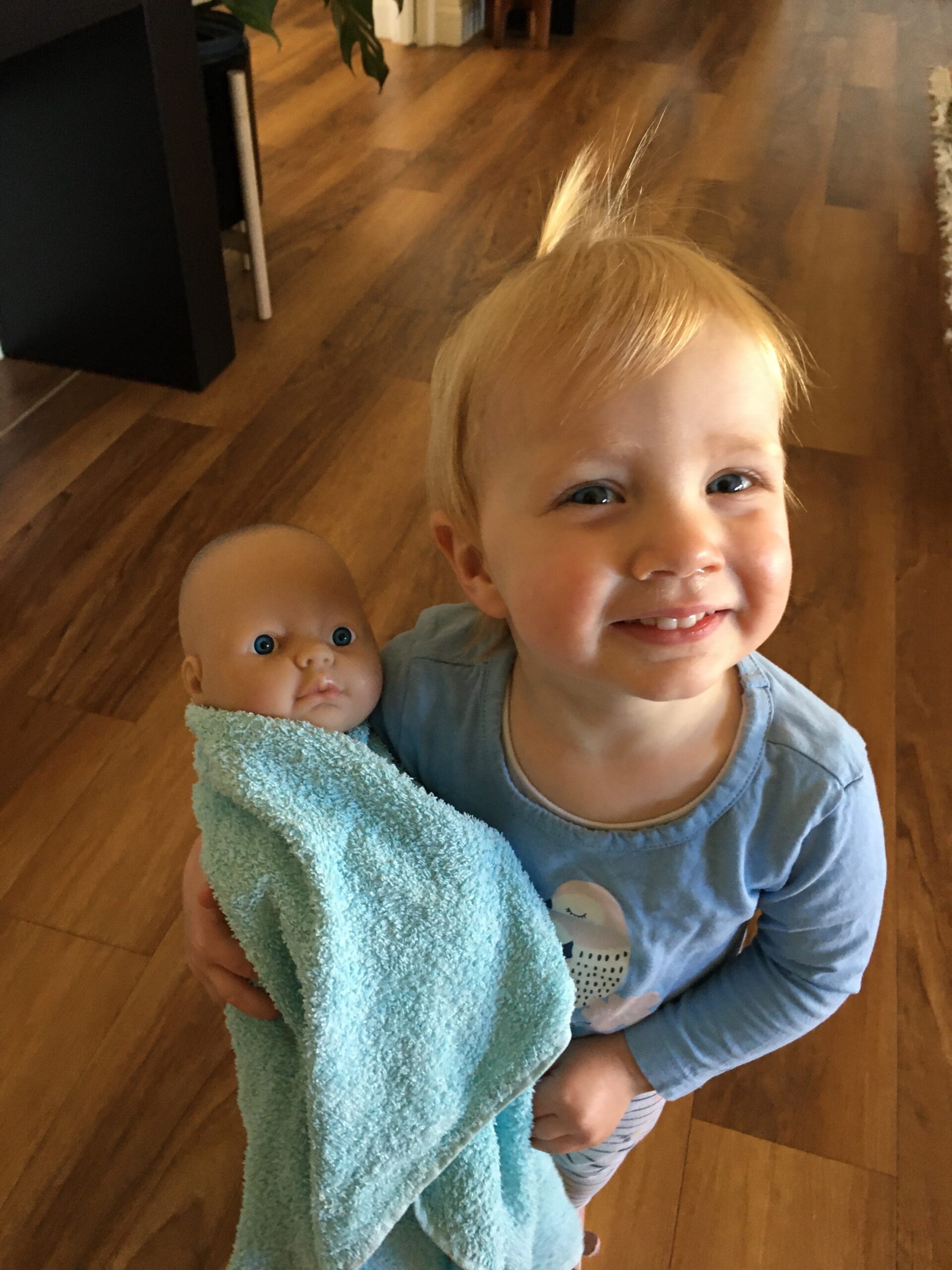 toddler with baby doll