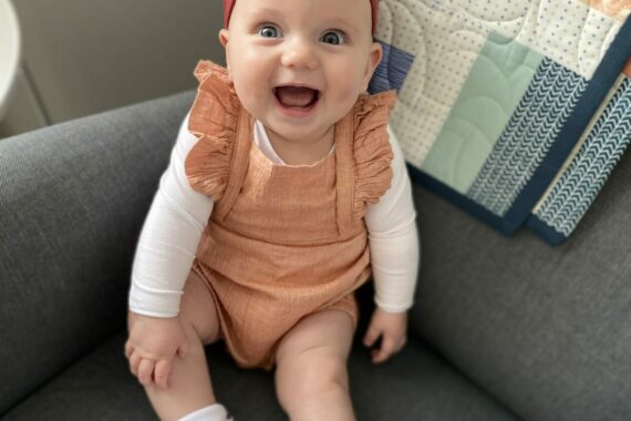 happy baby girl smiling on couch