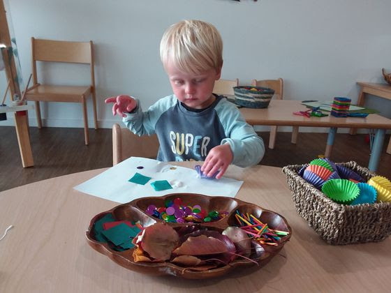 toddler boy doing arts and crafts at daycare