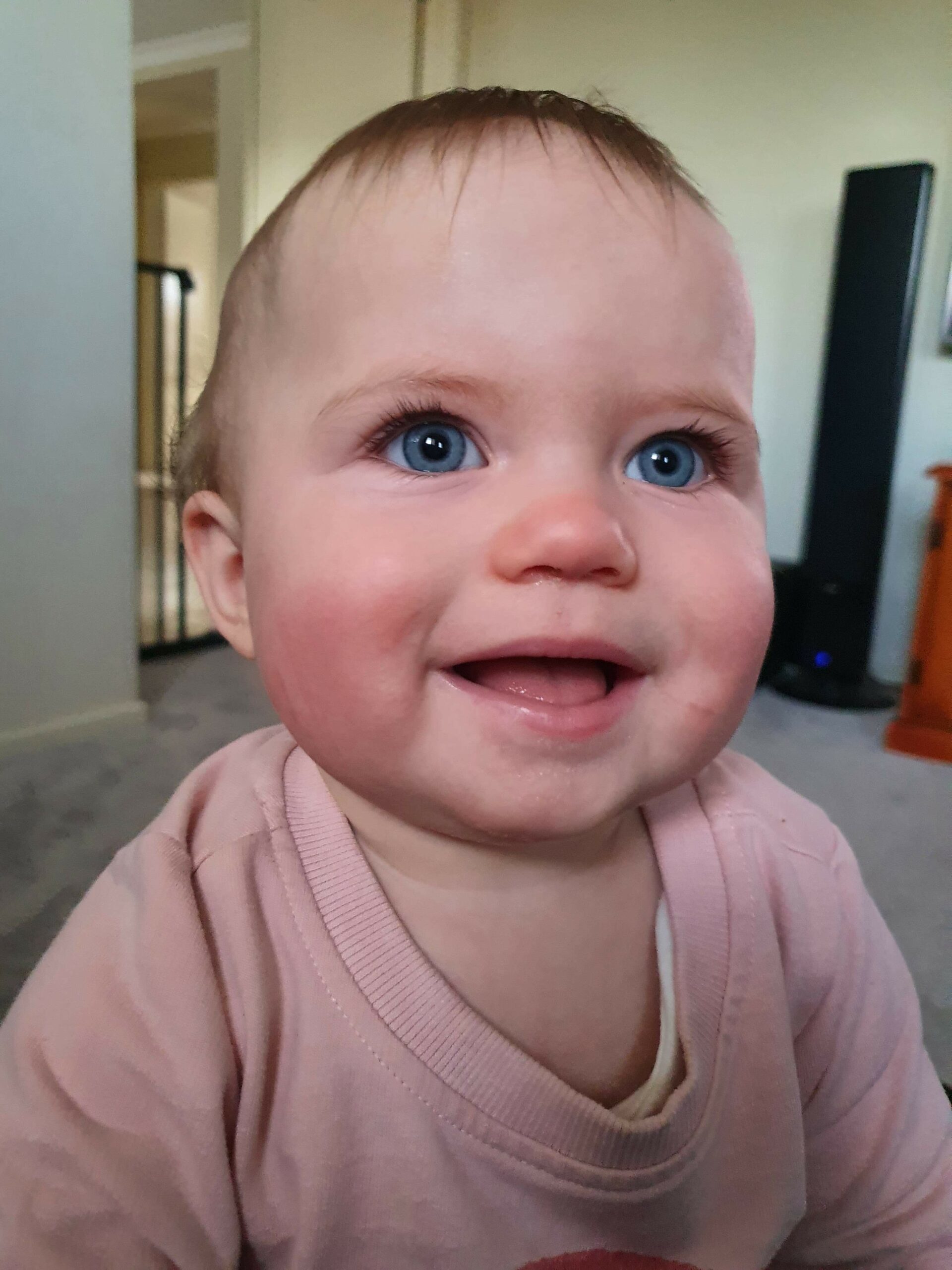 grey - eyed baby girl smiling