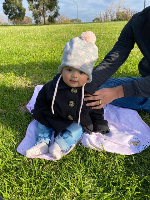 cosy baby sitting on grass