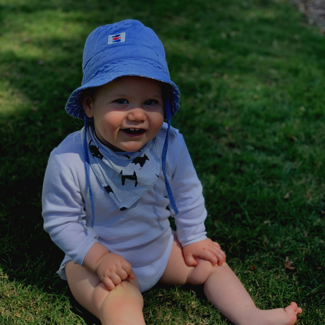 baby with hat laughing